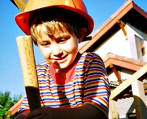 Grow the Can-DO DIY Mindset. Young Dale Stephens in construction hat helping his dad build a playhouse. LisaNalbone.com